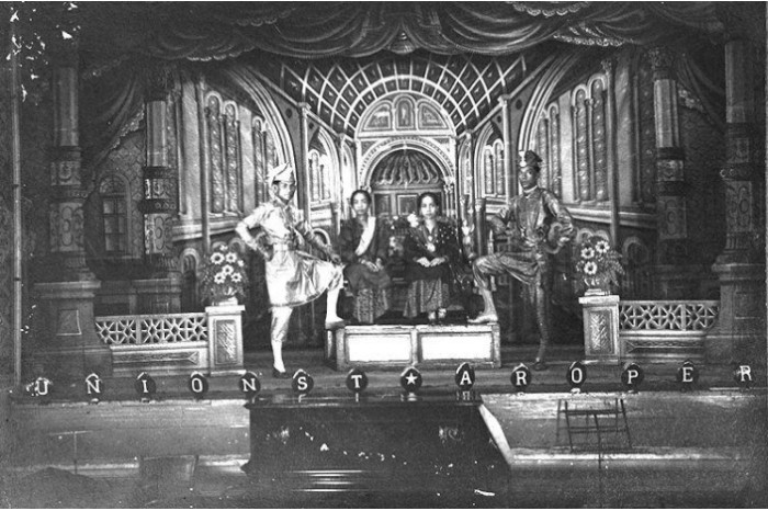 <strong><em>Bangsawan </em>actors posing in front of an elaborate stage backdrop, c. 1900</strong>